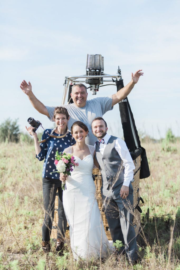Photographer Sara Ozim with hot air balloon elopement couple and painted horizons