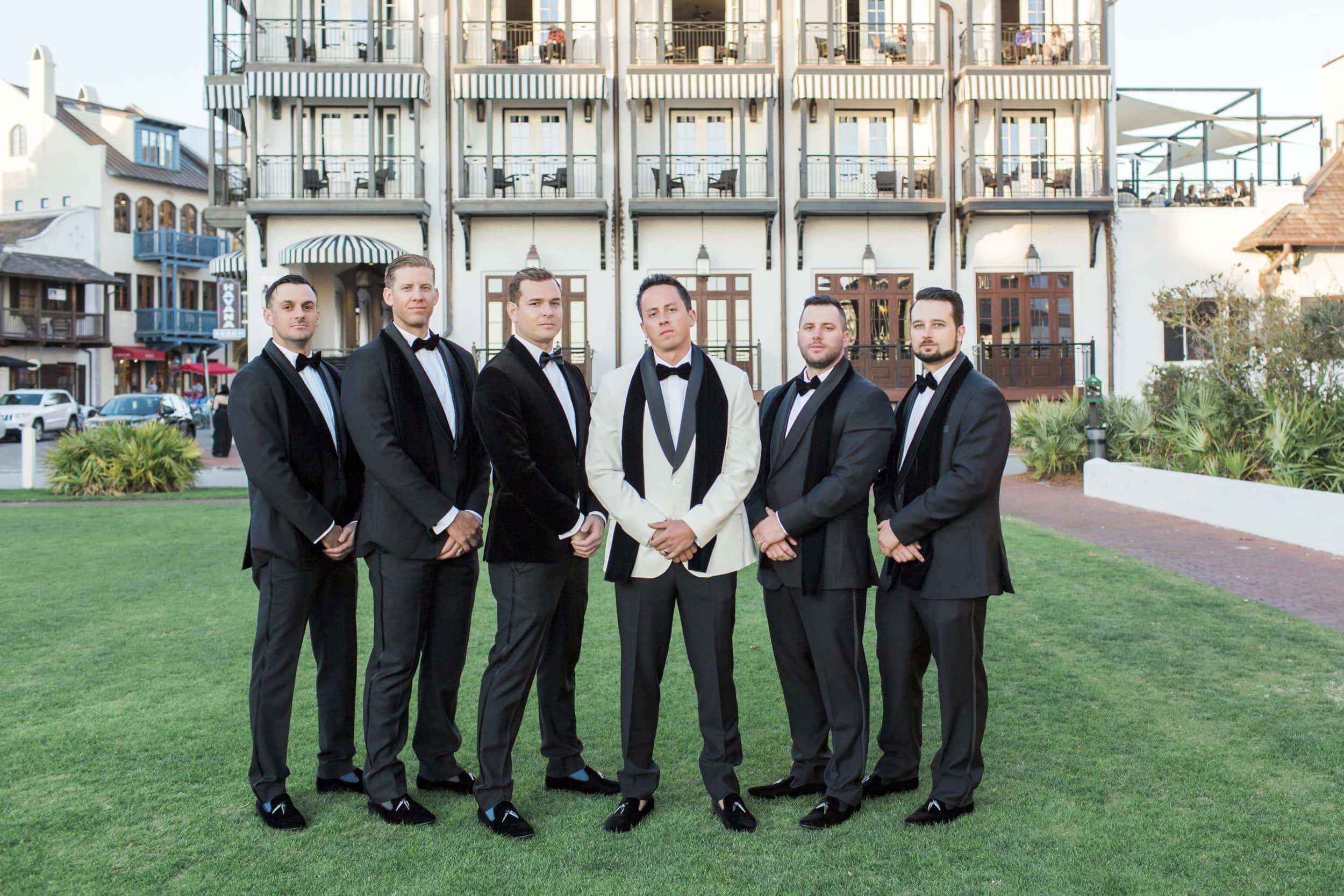 groomsmen standing in front of the pearl hotel in rosemary beach