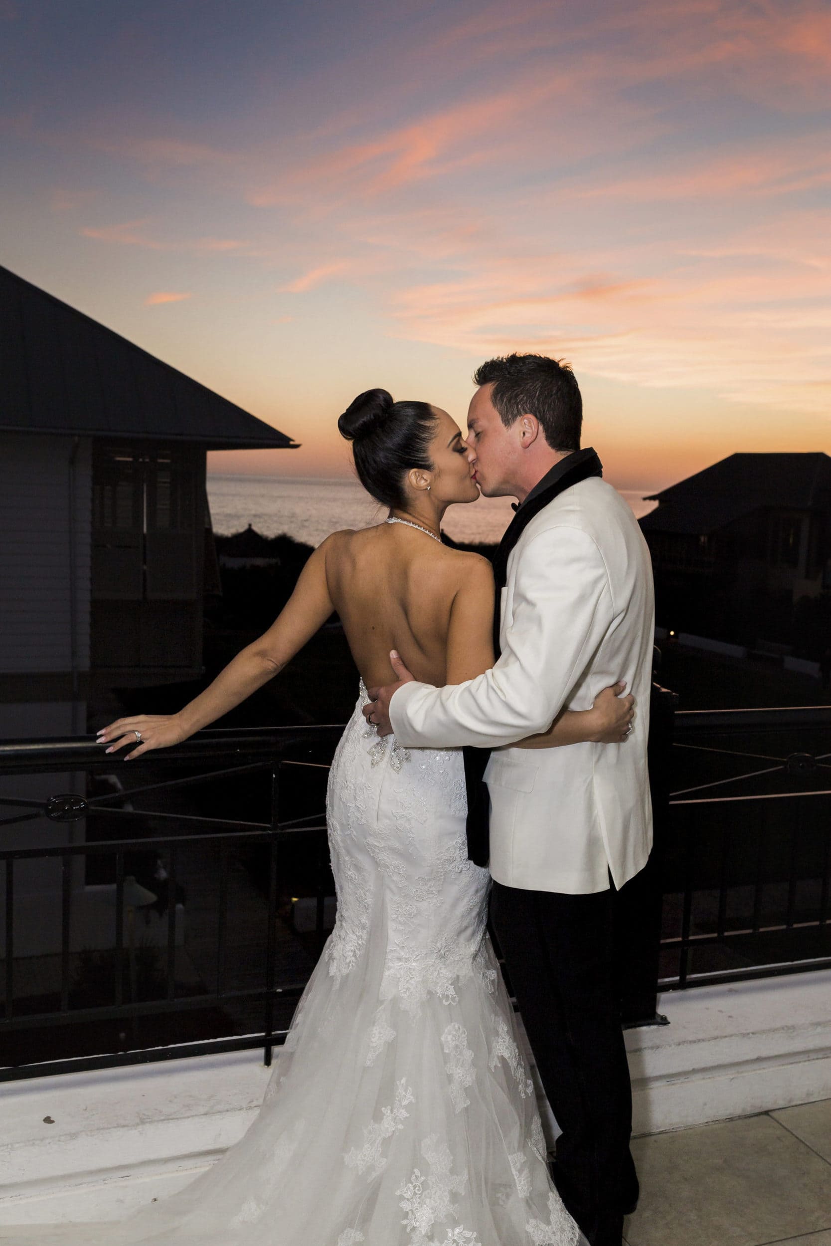 rosemary beach sunset picture with bride and groom kissing