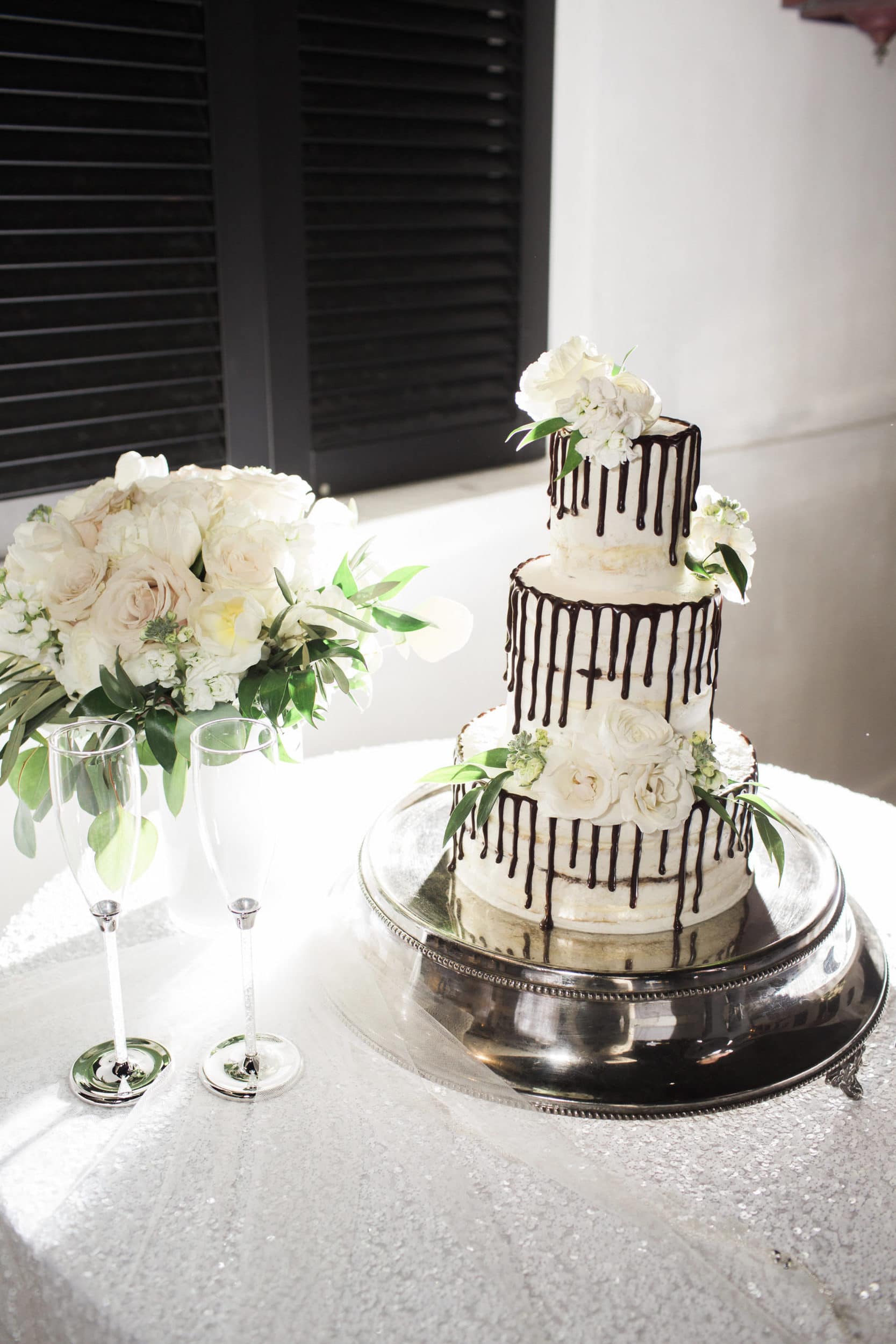 white wedding cake with dripping chocolate edges