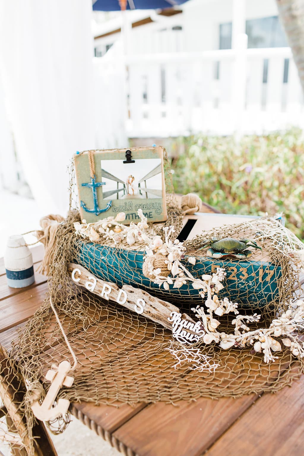 reception details with driftwood and greenery