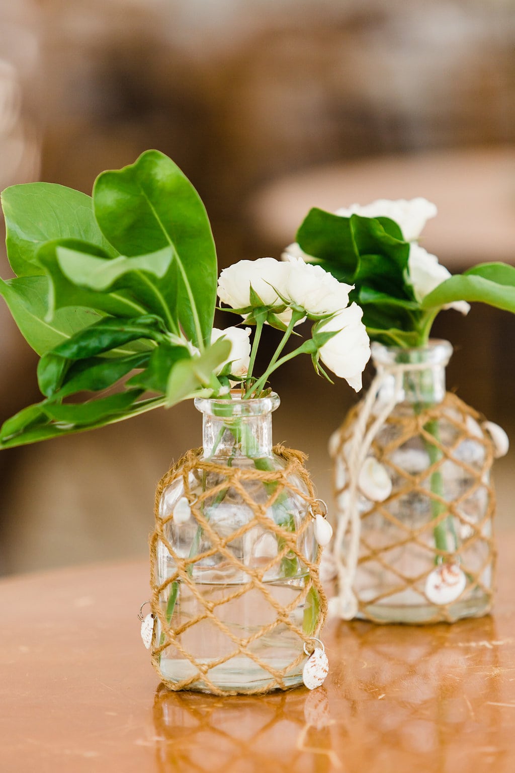 tropical reception details with clear centerpieces and white flowers and greenery