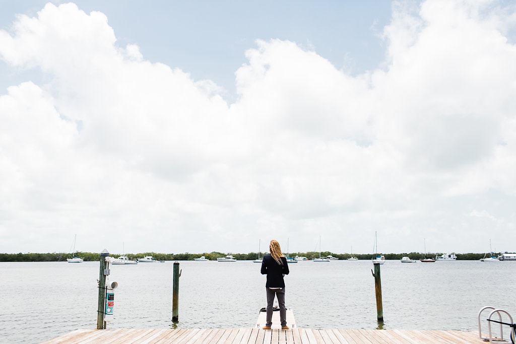 groom waiting for bride at the end of florida keys waterfront dock during first look