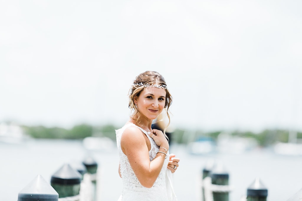 bride smiling back at camera just before first look on dock at coconut palm inn at a florida keys wedding 