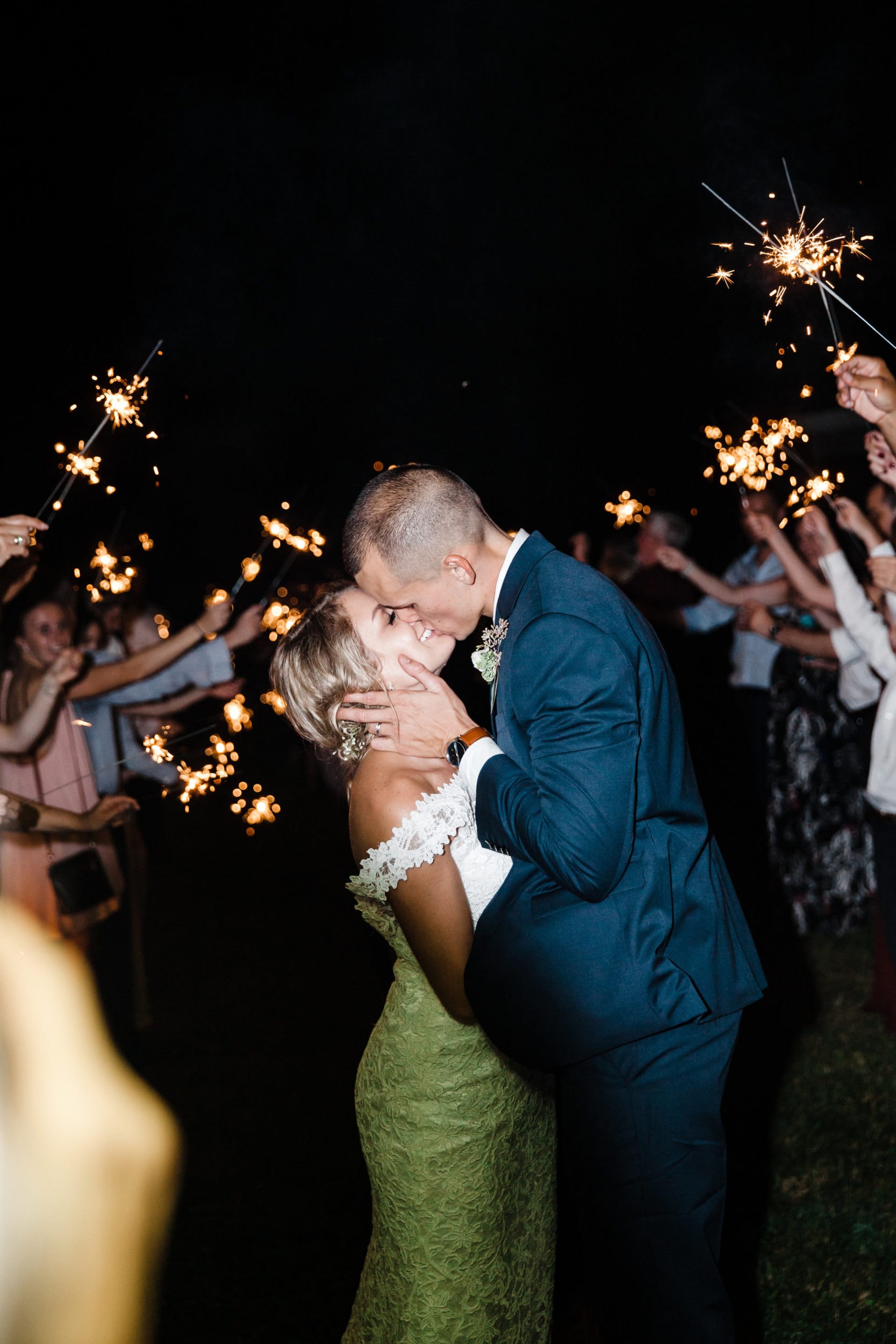 bride and groom kissing during sparkler exit at bramble tree estate