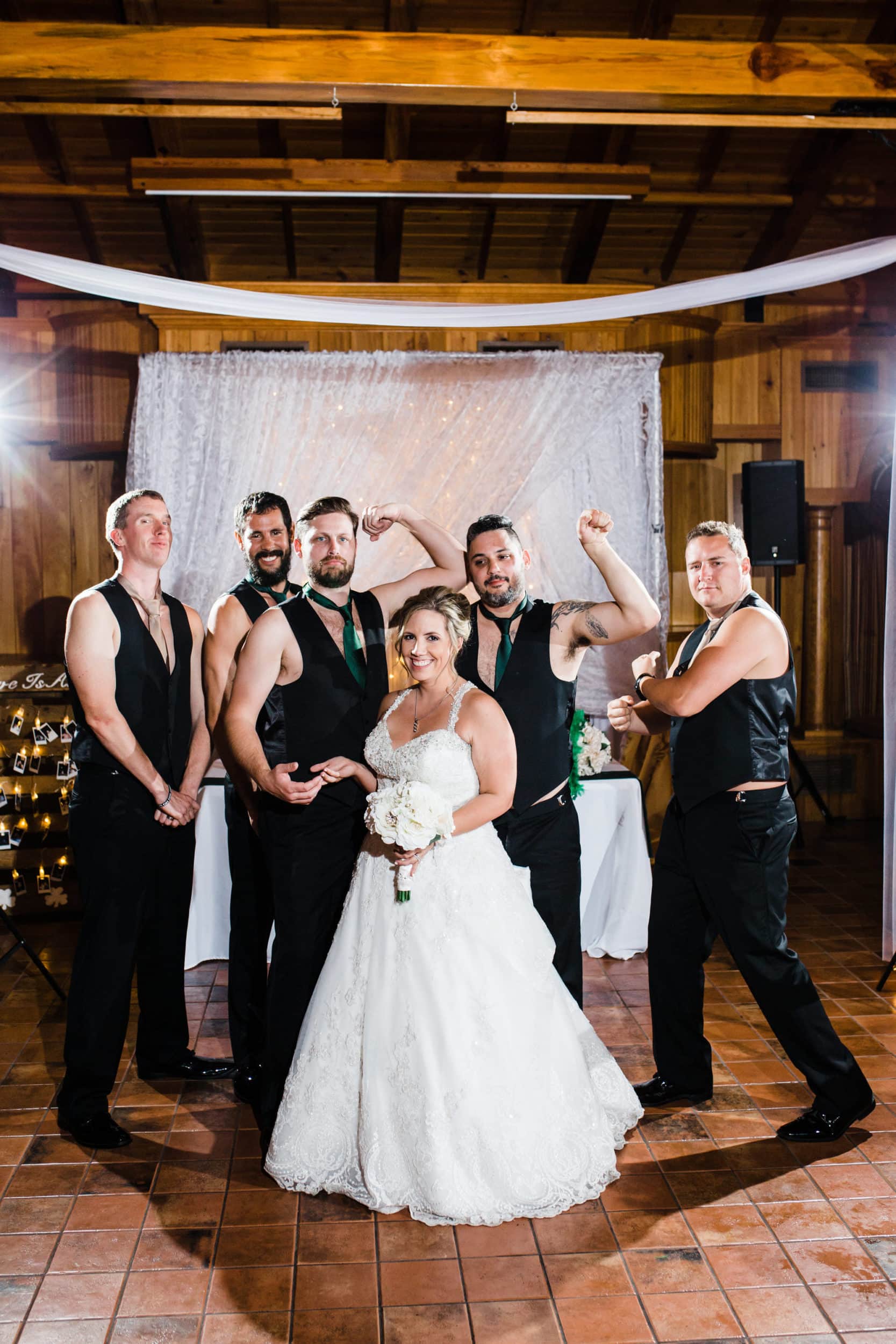 funny reception photo of bride with groomsmen at the estate on the halifax