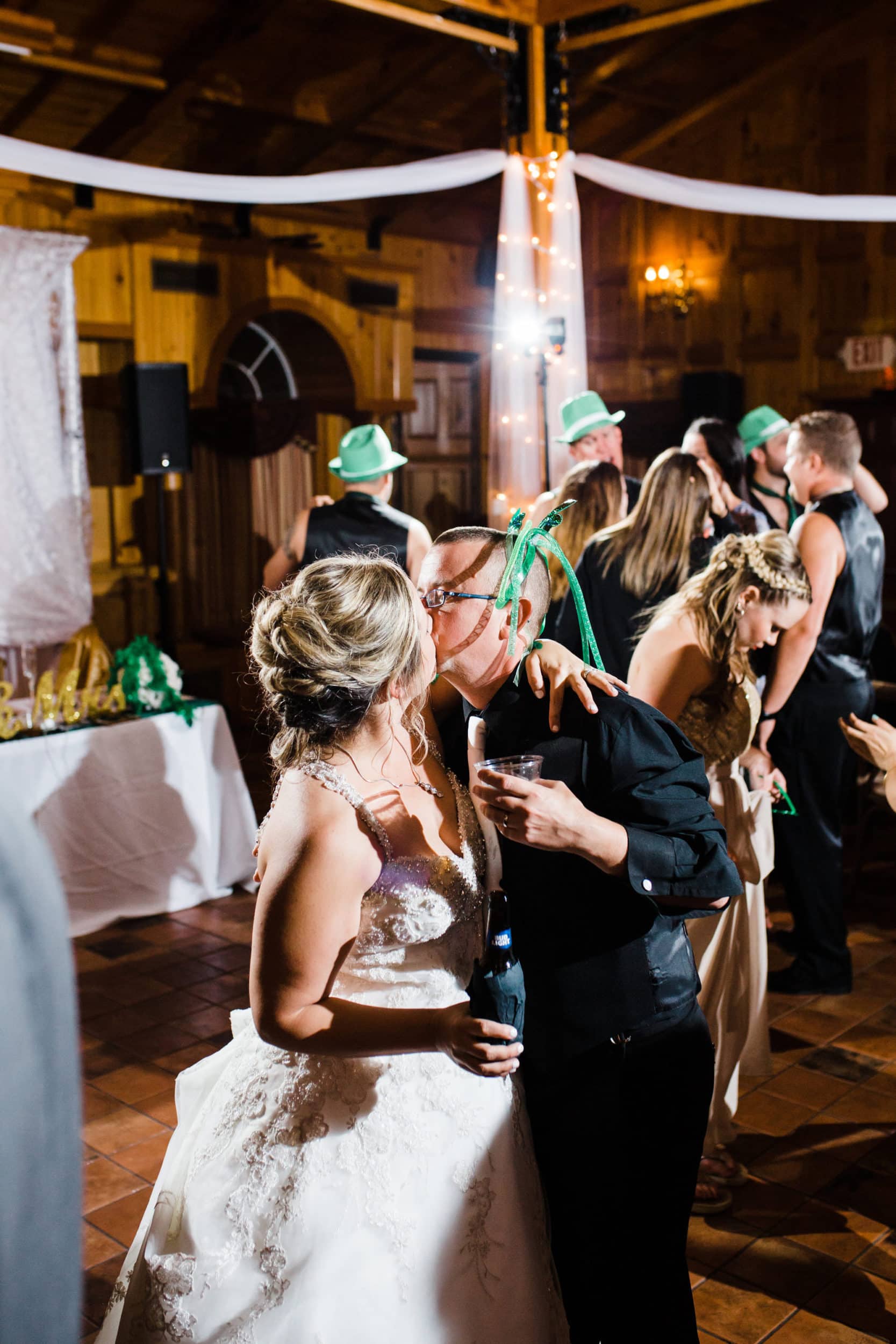 bride and groom kissing during st Patrick's day themed wedding at the estate on the halifax