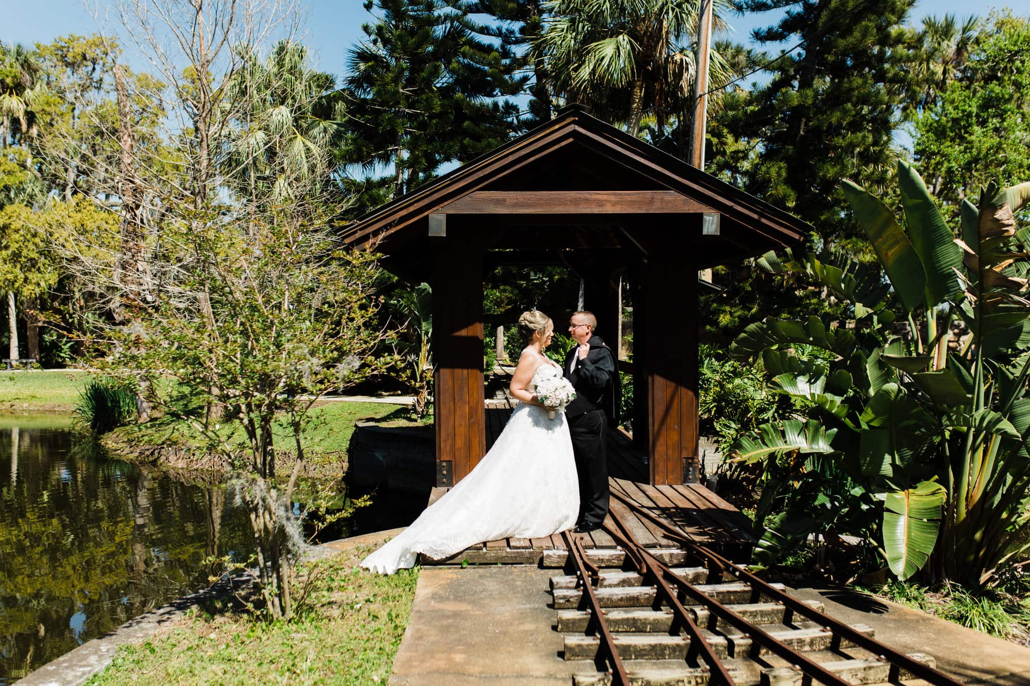 bride and groom standing on train tracks in front of bridge at estate on the Halifax wedding