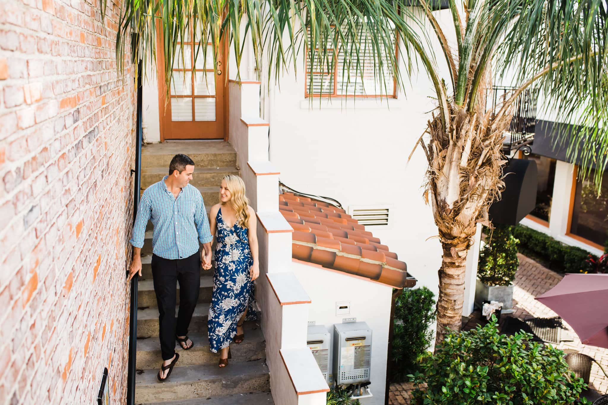 winter park engagement photos with palm trees and stucco ceilings