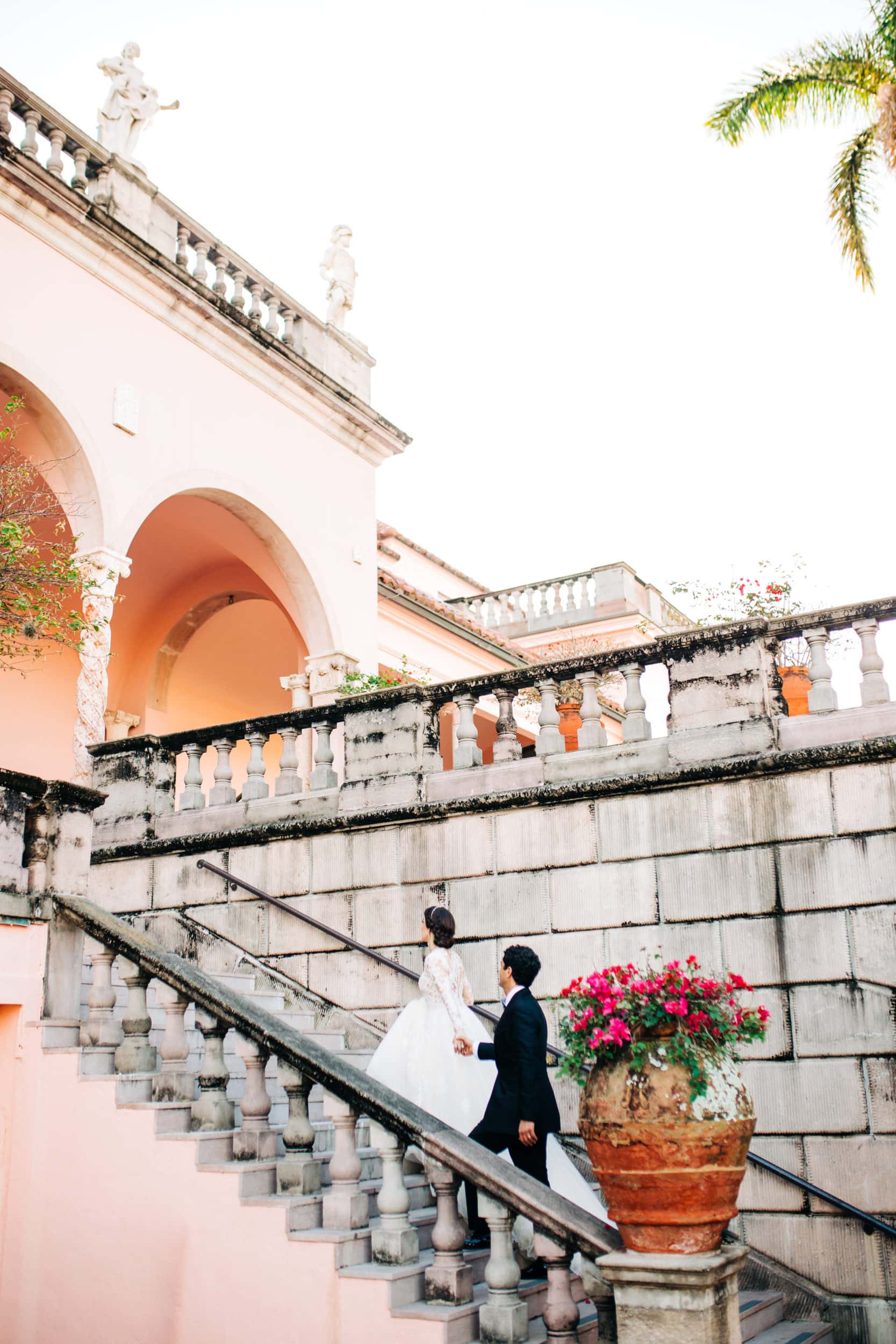 bride leading groom up stairs at The Ringling museum in sarasota florida