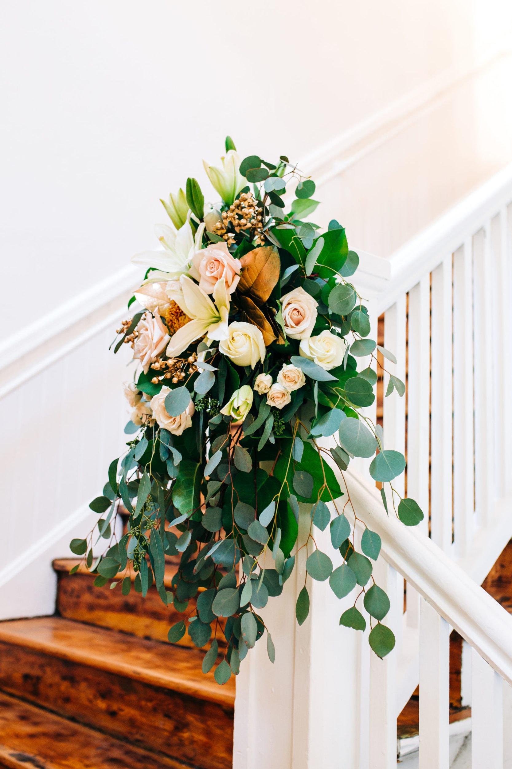 white, pink, and green floral decor on staircase