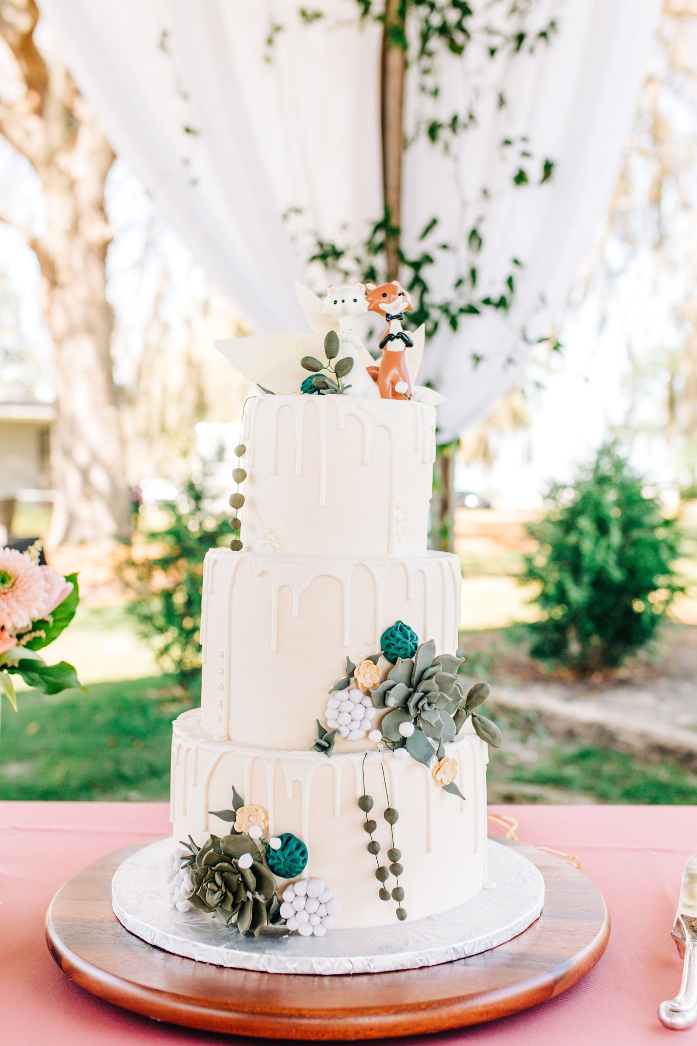 all white wedding cake with foxes