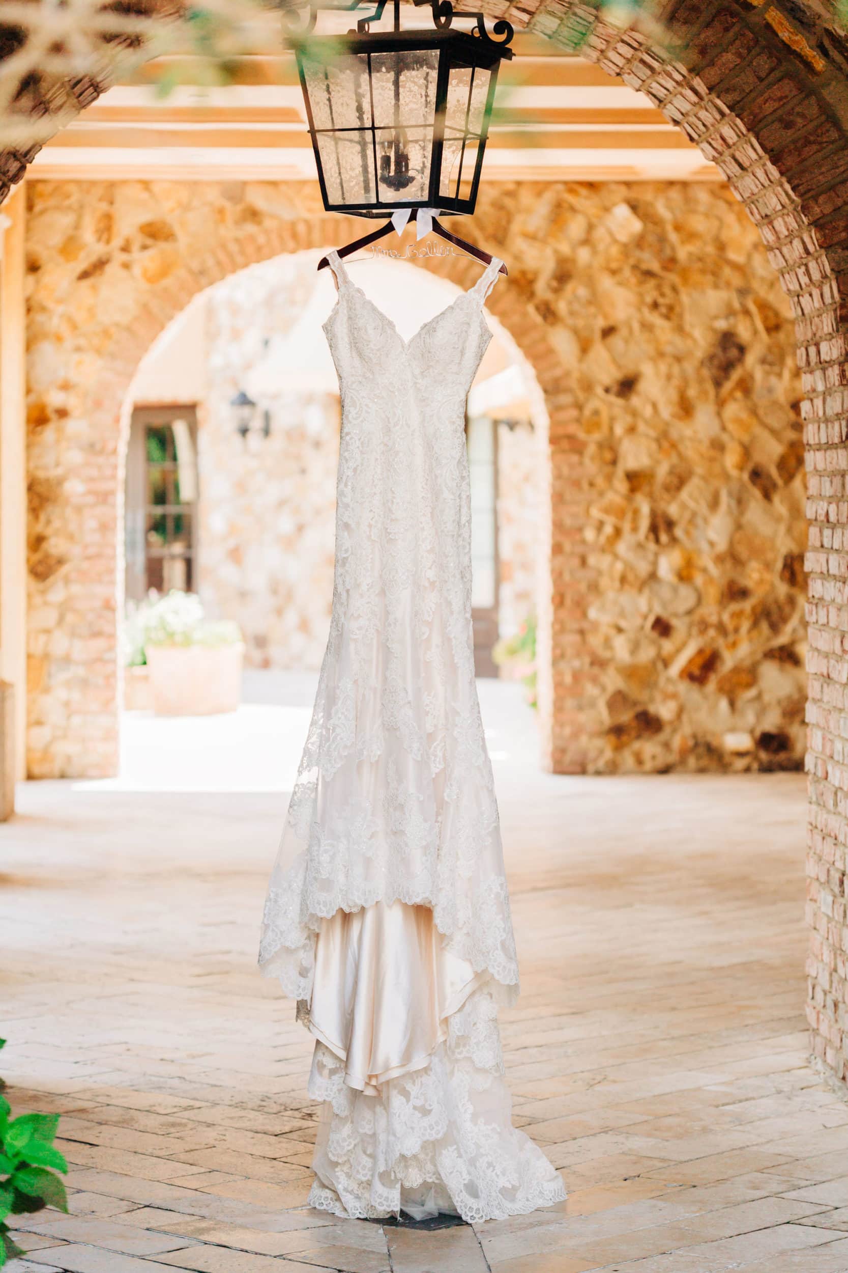 Eddy K Lace Bridal Gown hanging in Bella Collina Hallway