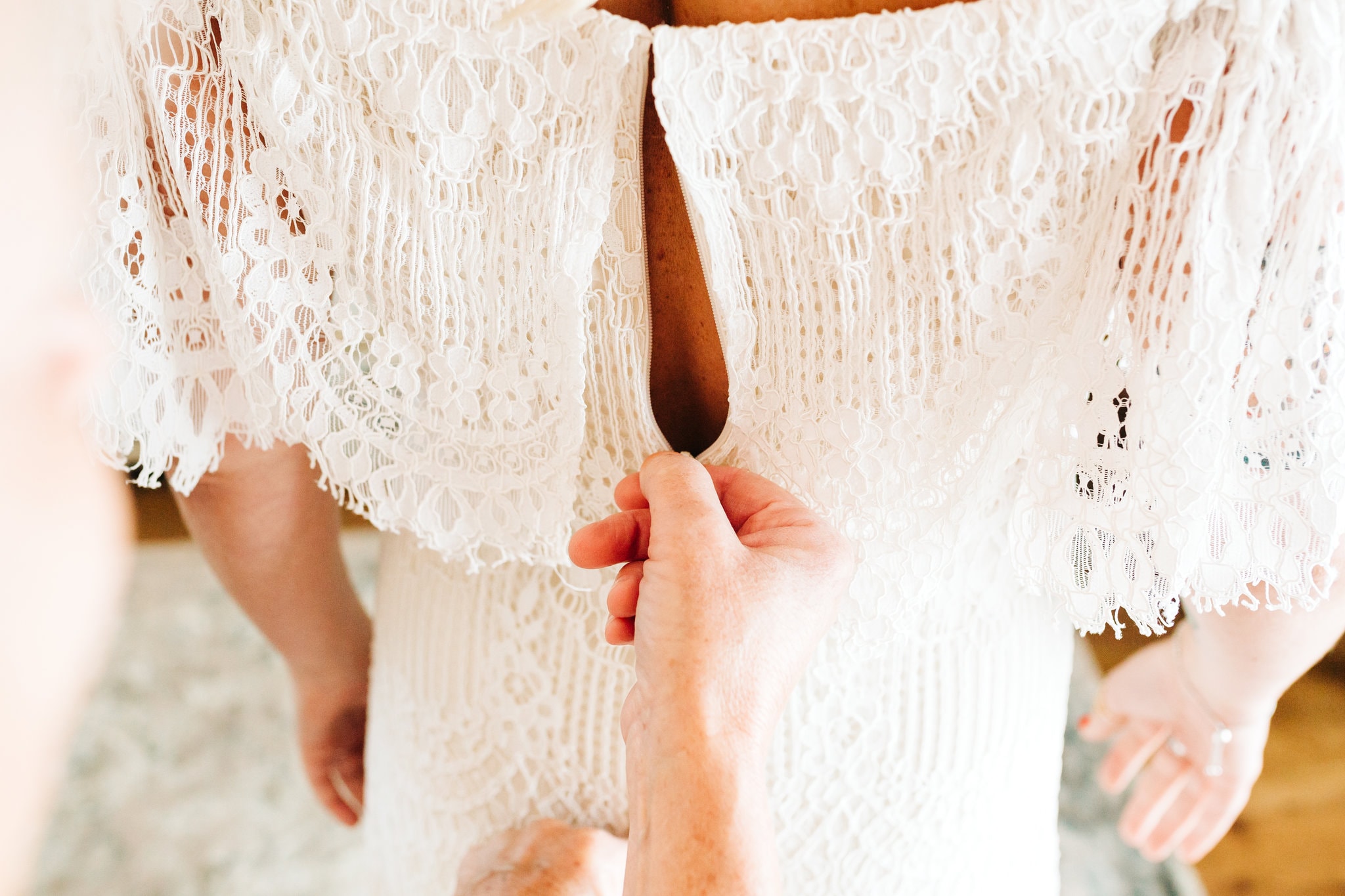 lace off the shoulder bridal dress zipping up at Boho Gambill Estate Wedding 