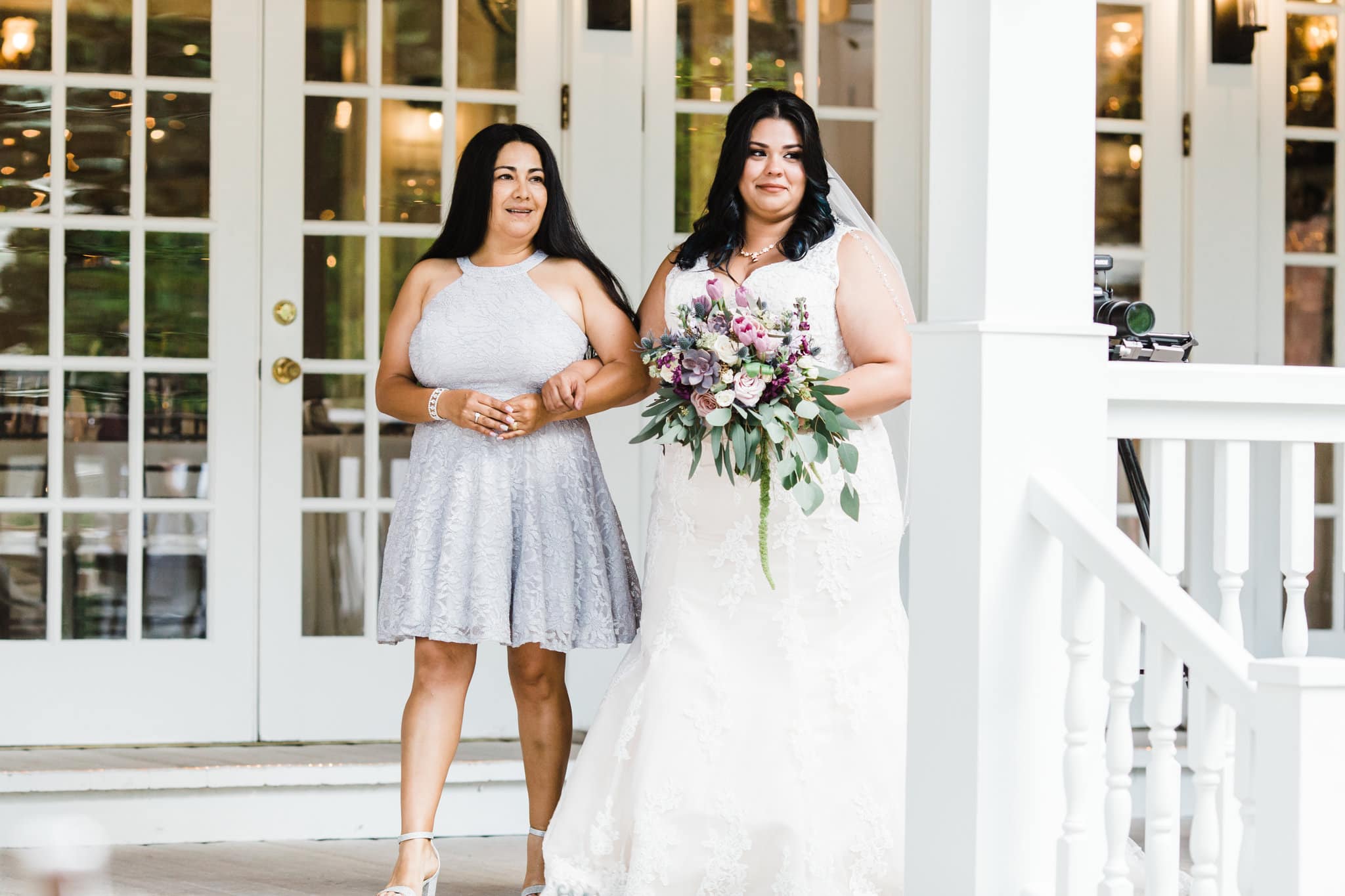 bride with white dress with veil with mother of bride with grey lace dress with succulent and white flowers at Dr Phillips House Wedding